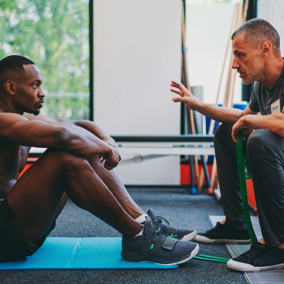 Athletic trainer talking with client